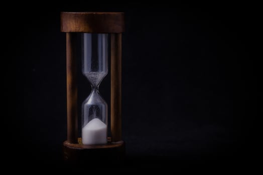 sand falling in hour glass photo