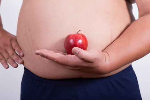 fat man with a apple in his hand photo