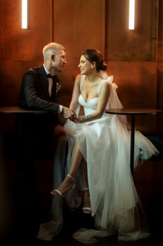 bride and groom inside a cocktail bar photo
