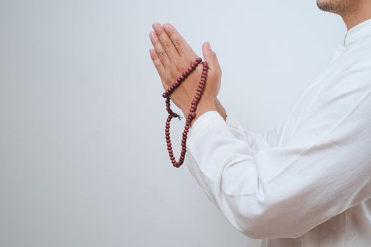 Close up Hand holding a tasbih or prayer beads photo