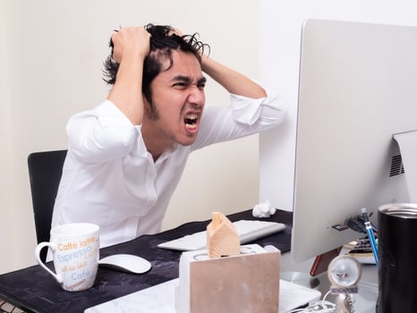 Serious Asian man is working with laptop in his apartment bedroom in concept of Work From Home and Work at Home photo
