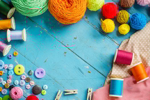Sewing background. Accessories for needlework on old wooden background. photo