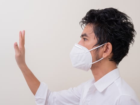 Asian young man in white shirt and medical mask to protect COVID-19 photo
