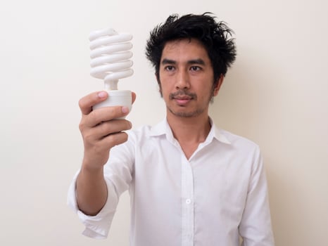 Man holding energy saving bulb for lamp photo