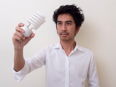 Man holding energy saving bulb for lamp photo