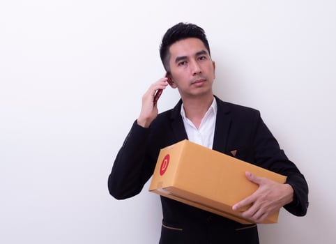 Shipper young Asian man holding cardboard box photo