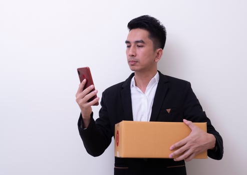Shipper young Asian man holding cardboard box photo