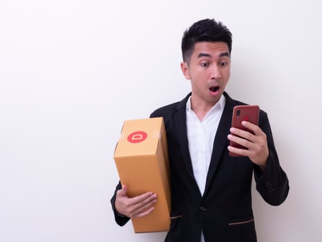 Shipper young Asian man holding cardboard box photo
