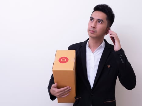 Shipper young Asian man holding cardboard box photo
