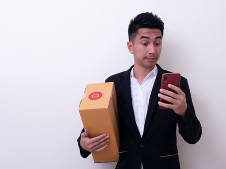 Shipper young Asian man holding cardboard box photo
