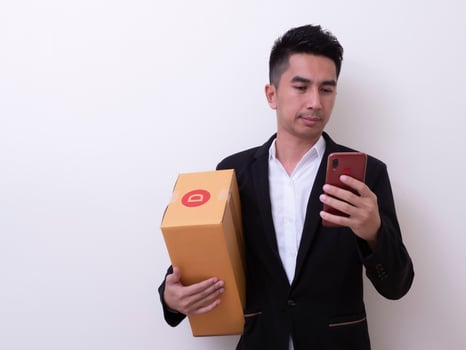 Shipper young Asian man holding cardboard box photo