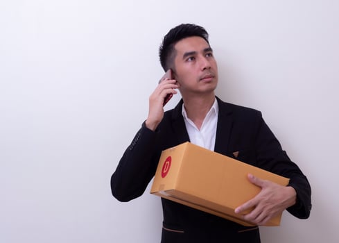 Shipper young Asian man holding cardboard box photo