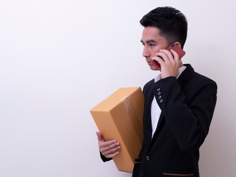 Shipper young Asian man holding cardboard box photo