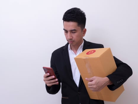 Shipper young Asian man holding cardboard box photo