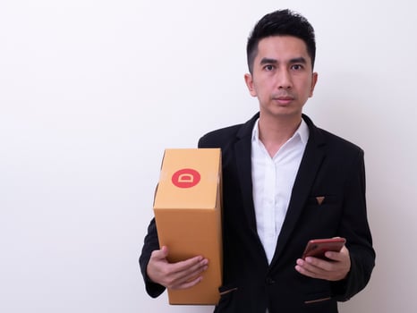 Shipper young Asian man holding cardboard box photo
