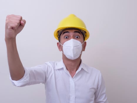 Asian industrial workers wear yellow hard hats, wear protective masks for their health photo