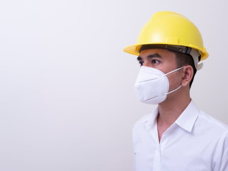 Asian industrial workers wear yellow hard hats, wear protective masks for their health photo