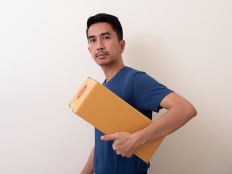 young man holding a box isolated on a white background photo