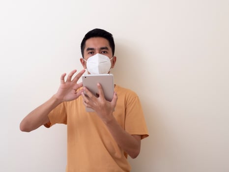 Young Man Holding Digital Tablet Against White Background photo