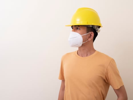Asian industrial workers wear yellow hard hats, wear protective masks for their health photo