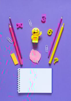 Back to school concept. School and office supplies on the office table. Violet background.Flat lay photo