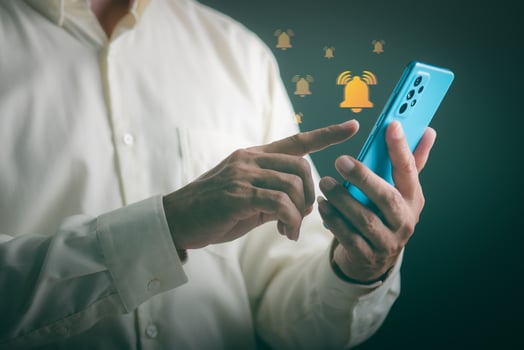 young businessman looking at phone with notification, photo