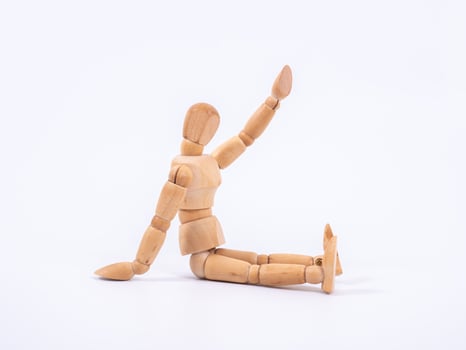 The wooden dummy sits on white background photo