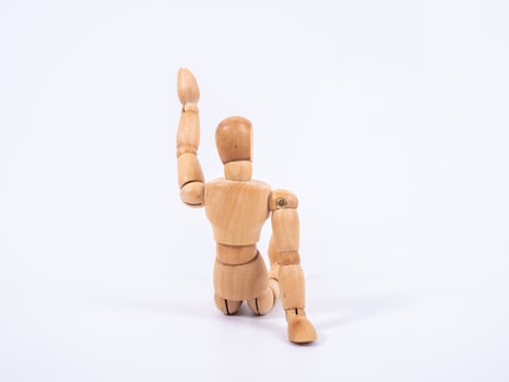 The wooden dummy sits on white background photo
