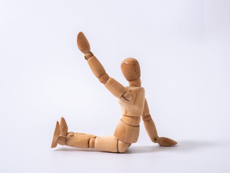 The wooden dummy sits on white background photo