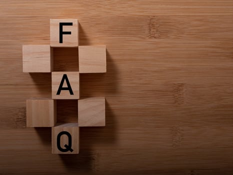 closeup of wooden word on wooden table background concept - FAQ photo