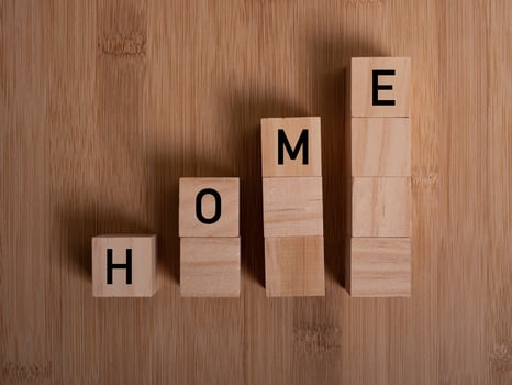 HOME concept with wooden block on wooden photo