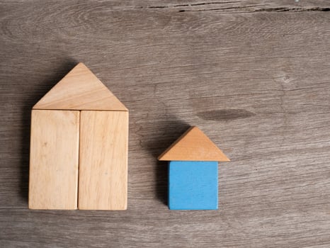 Wooden house toy with wood background photo