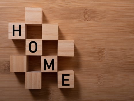 HOME concept with wooden block on wooden photo