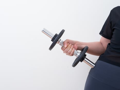 hand holding dumbbell isolated on white background photo