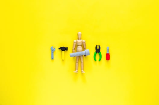 Wooden model with tools and equipment for work in construction. Minimal Labour day concept. photo
