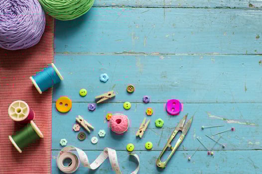 Sewing background. Accessories for needlework on old wooden background. photo