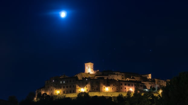 Panorama  night with the moon of Anghiari medieval village in Tuscany - Italy photo