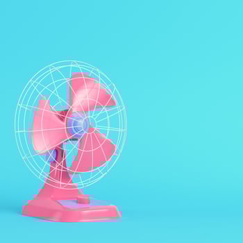 Pink electric fan on bright blue background in pastel colors photo