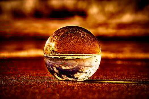 Abstract representation of a glass ball on the beach at the Baltic Sea. photo