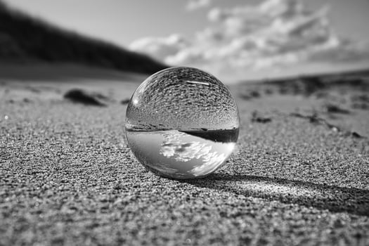 glass globe on the beach of the baltic sea. photo
