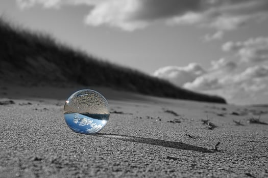 glass globe on the beach of the baltic sea. photo