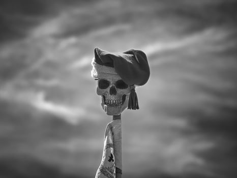 skull on a stick with cap. Taken at a medieval festival photo