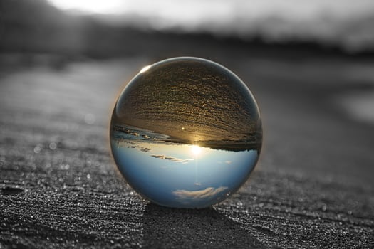 Glass globe on the beach of the Baltic Sea in Zingst in which the landscape is depicted. photo