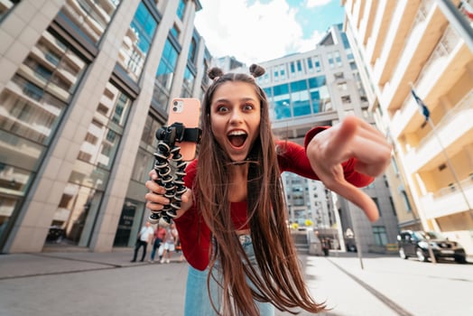 Beautiful female blogger looking at the camera on the street. photo