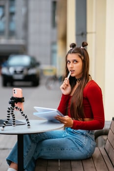 Freelancer woman in a summer cafe doing remote work. photo