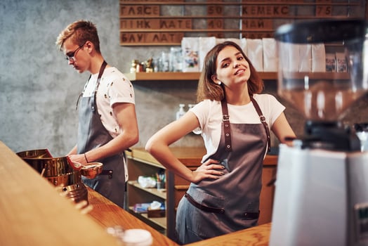 Positive mood. Two young cafe workers indoors. Conception of business and service photo