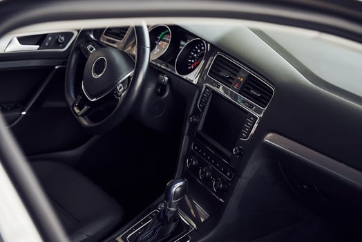 Inside of brand new modern electrical car. Particle view. Cropped photo