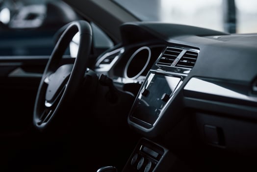 Elegant but simple design. Front part of brand new automobile. Modern black interior. Conception of vehicles photo