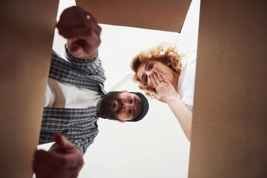 Feels shocked. Happy couple together in their new house. Conception of moving photo