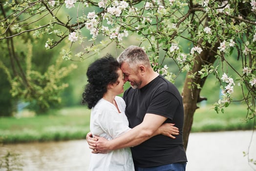 Smiling and embracing. Cheerful couple enjoying nice weekend outdoors. Good spring weather photo
